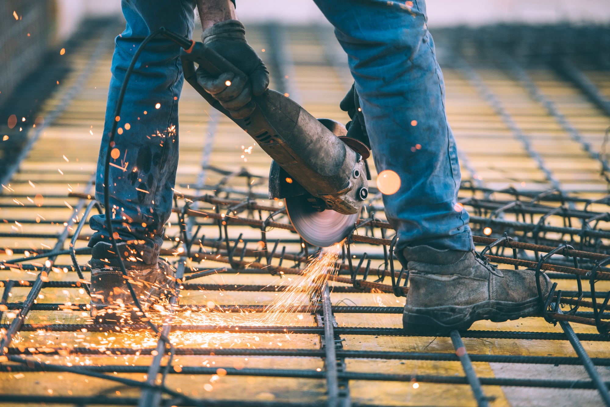 Industrial construction engineer cutting steel