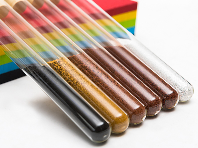 Pigment samples in test tubes, showcasing various colors of iron oxide pigments